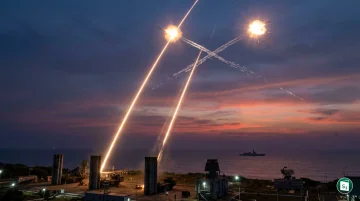 A long-range interceptor missile launching from a mobile platform at night