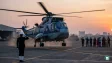 A Sea King helicopter flying over the sea during a ceremonial naval flight